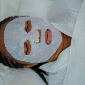 Home Woman enjoying a rejuvenating facial mask treatment at a spa in Abuja, Nigeria.